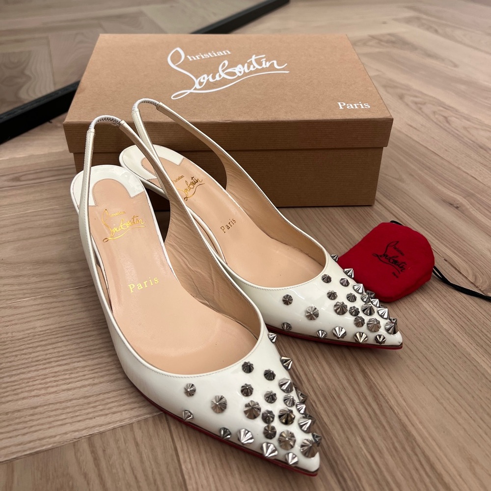 CHRISTIAN LOUBOUTIN
Drama Sling 70 spiked patent-leather slingback pumps.